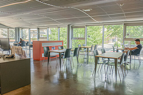 Salle de travail avec des tables et chaises